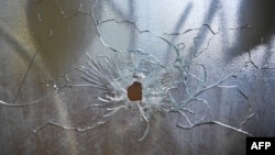 FILE - A bullet hole is seen in a glass door after an armed attack forced the closure of Fontaine Hospital in the Cité Soleil district of Port-au-Prince, Haiti, Nov. 18, 2023. 