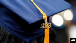 FILE - A tassel with 2023 on it rests on a graduation cap as students walk in a procession for Howard University's commencement in Washington, May 13, 2023.