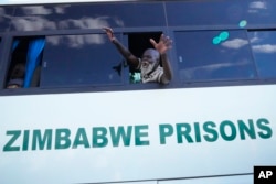 A freed prisoner celebrates after he was released from Harare Central Prison in Harare, Zimbabwe, May, 19, 2023. Zimbabwe has started releasing more than 4,000 prisoners under a presidential amnesty authorities say will help ease overcrowding in some jails.