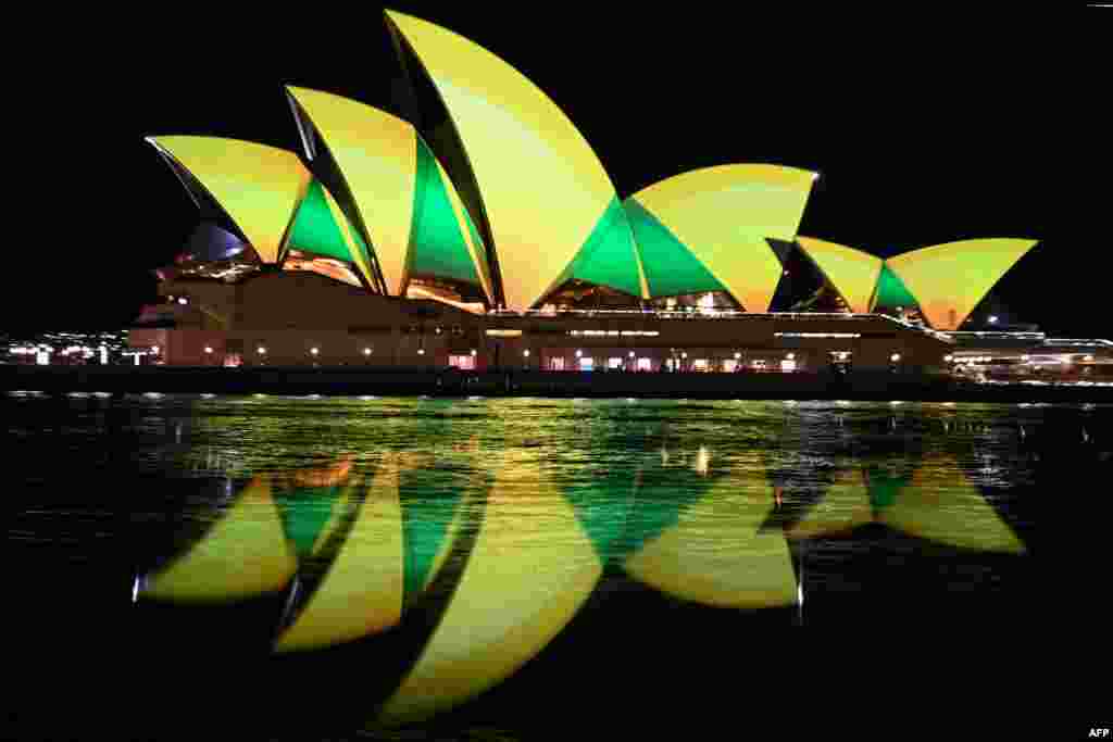 The Sydney Opera House is illuminated in green and gold in Sydney to support the Australia&#39;s women&#39;s football team ahead of their first World Cup knock-out round match against Denmark.