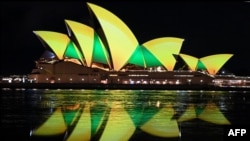 The Sydney Opera House is illuminated in green and gold in Sydney to support the Australia&#39;s women&#39;s football team ahead of their first World Cup knock-out round match against Denmark.