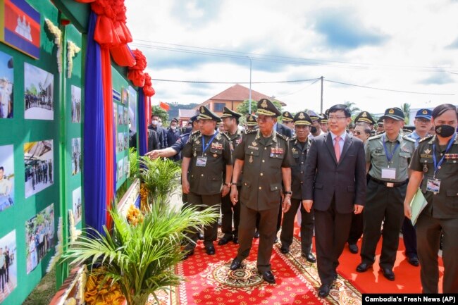 Cambodian Defense Minister Tea Banh, center left, and Chinese Ambassador to Cambodia Wang Wentian, center right, visit the site of the groundbreaking ceremony for a shipyard repairing and restoration workshop in Ream Cambodian Naval Base of Sihanoukville, June 8, 2022. (Cambodia's Fresh News via AP)