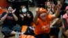 Supporters of Move Forward party cheer as they watch the counting of votes on television at Move Forward Party headquarters in Bangkok, Thailand, May 14, 2023. 