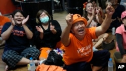 Supporters of Move Forward party cheer as they watch the counting of votes on television at Move Forward Party headquarters in Bangkok, Thailand, May 14, 2023. 