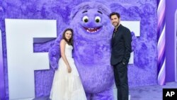 Cailey Fleming, left, and John Krasinski pose with the character "Blue" at the premiere of Paramount Pictures' "IF" at the SVA Theatre in New York, May 13, 2024. (Evan Agostini/Invision/AP)