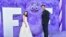 Cailey Fleming, left, and John Krasinski pose with the character "Blue" at the premiere of Paramount Pictures' "IF" at the SVA Theatre in New York, May 13, 2024. (Evan Agostini/Invision/AP)