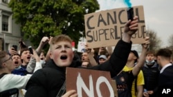 FILE - Chelsea fans protest outside Stamford Bridge stadium in London, against Chelsea's decision to be included amongst the clubs attempting to form a new European Super League, Tuesday, April 20, 2021. 