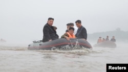 North Korean leader Kim Jong Un and Premier Kim Tok Hun visit a flood-affected area near the border with China, in North Pyongan province, in this undated photo released July 31, 2024 by North Korea's official Korean Central News Agency.