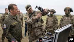 FILE - Russian Security Council Deputy Chairman Dmitry Medvedev, left, visits a military training ground in Volgograd, Russia, on June 1, 2023. The U.S. on Aug. 16, 2023, imposed sanctions on three entities it accused of being tied to arms deals between North Korea and Russia