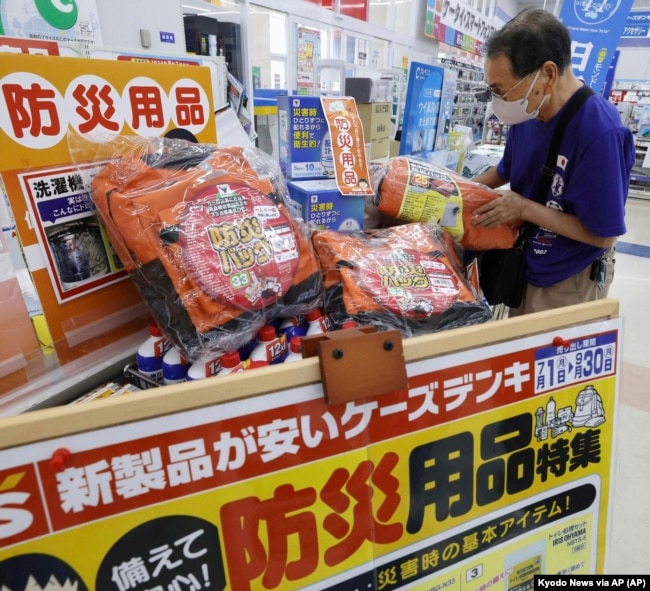 A person checks emergency kit sold at a shop following a strong earthquake in Shibushi, Kagoshima prefecture, southern Japan, on Aug. 9, 2024. (Kyodo News via AP)