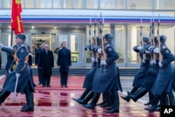 In this photo released by the Syrian official news agency SANA, visiting Syrian President Bashar al-Assad, right, reviews an honor guard during a welcome ceremony upon his arrival at Vnukovo airport in Moscow, Russia, March 14, 2023.