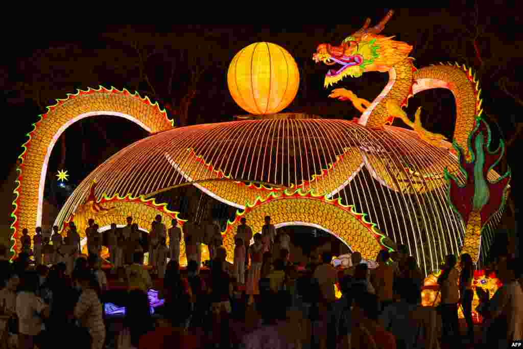 People visit a dragon lantern decoration with energy-saving LED lights ahead of the lunar new year at the Fo Guang Shan Dong Zen temple in Jenjarom, some 50 kilometers southwest of Kuala Lumpur.