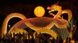 People visit a dragon lantern decoration with energy-saving LED lights ahead of the lunar new year at the Fo Guang Shan Dong Zen temple in Jenjarom, some 50 kilometers southwest of Kuala Lumpur.