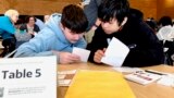 Meadowdale High School students Juanangel Avila, right, and Legacy Marshall work solve an exercise at MisinfoDay March 14, 2023, in Seattle.