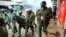 FILE - Riot policemen walk back during clashes with protesters in the Kibera area of Nairobi, Kenya, on July 19, 2023. Kenya has offered to lead an international police force aimed at combating Haiti's gang violence. 