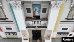 An Image of Pope John Paul II is seen on the Basilica of the Presentation of the Blessed Virgin Mary in Wadowice, the birth place of Pope John Paul II, Poland, March 15, 2023. 