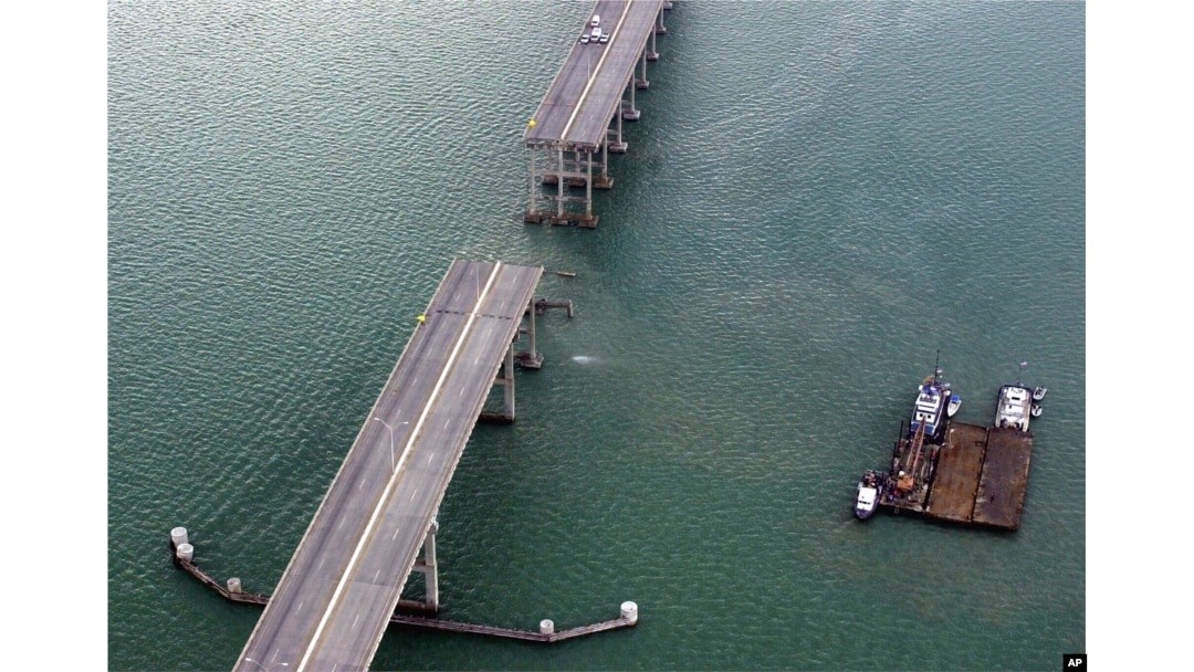 FILE - A section of the Queen Isabella Causeway is shown missing as crews break from their search and rescue due to a storm in Port Isabella, Texas, Sept. 15, 2001.