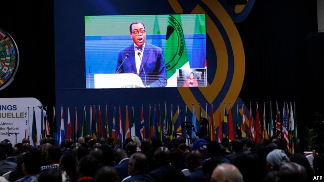 Delegates watch a screen that broadcasts a speech of President of the African Development Bank Akinwumi Adesina at the Kenyatta International Convention Centre in Nairobi on May 29, 2024.
