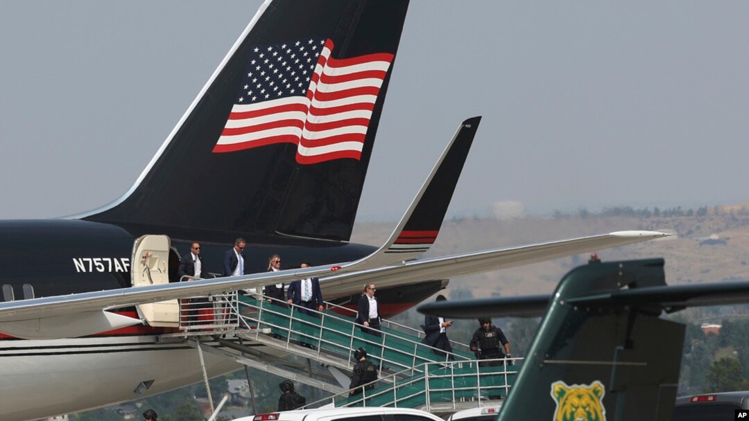 Members of former President Donald Trump's team disembark from his Boeing 757 after arriving at the Billings Logan International Airport in Billings, Mont., Aug. 9, 2024, en route to Bozeman. 