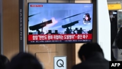 2024年1月5日，韩国首尔的一个火车站，人们观看电视屏幕上播放的新闻，其中有朝鲜炮击的档案画面。