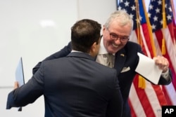 New Jersey Governor Phil Murphy, right, greets George Helmy after announcing that Helmy will take the U.S. Senate seat that will soon be vacated by Senator Bob Menendez, in Newark, N.J., Aug. 16, 2024.