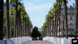 A man walks on the Louis Philippe bridge inside the security perimeter set up for the Olympic Games in Paris, July 18, 2024.