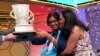 FILE - Harini Logan, 14, from San Antonio, Texas, gets a kiss from her mom Rampriya Logan on stage as she celebrates winning the Scripps National Spelling Bee, June 2, 2022, in Oxon Hill, Md. 