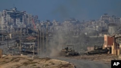 Israeli army tanks are seen in Wadi Gaza, central Gaza Strip, June 26, 2024.
