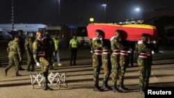 The body of late Ghanaian soccer player, Christian Atsu Twasam, 31, who died in the earthquake in Turkey, arrives at the Kotoka International Airport in Accra, Ghana. Feb. 19, 2023.