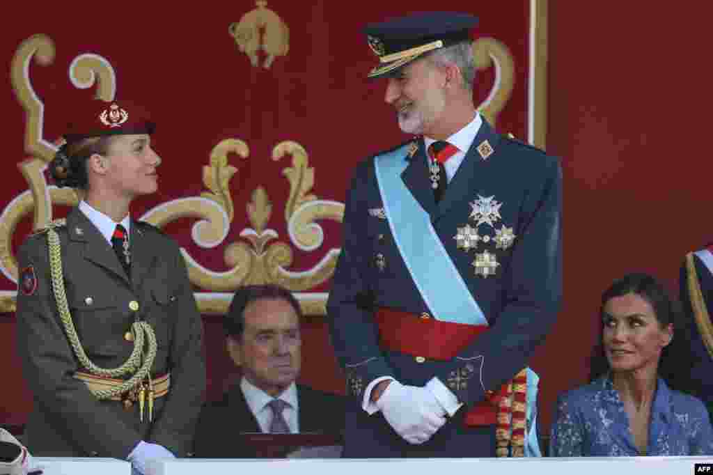 (From L) Spanish Crown Princess of Asturias Leonor, King Felipe VI and Queen Letizia attend the Spanish National Day military parade in Madrid.