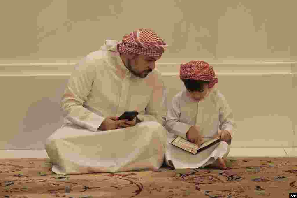 A child reads the Quran during prayers at the Sheikh Zayed Grand Mosque in Abu Dhabi, Qatar, on Laylat al-Qadr, one of the holiest nights during the Muslim holy fasting month of Ramadan.