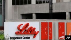 FILE - A sign for Eli Lilly & Co. sits outside the company's corporate headquarters in Indianapolis on April 26, 2017. In a large study, Lilly's experimental Alzheimer’s drug appeared to slow worsening of the mind-robbing disease, the company said on May 3, 2023.
