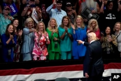 Republican presidential candidate former President Donald Trump greets supporters as he departs after speaking at a campaign event in Grand Rapids, Michigan, July 20, 2024.