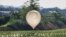 FILE - A balloon believed to have been sent by North Korea, carrying what appeared to be trash and excrement, is seen over a field at Cheorwon, South Korea, May 29, 2024. The military in Seoul said on Aug. 10 that the North is again flying trash balloons. (Yonhap via Reuters)