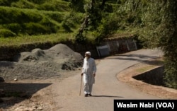 A man walks on a road in Totta Gali on June 19, 2023. People in Poonch district are afraid to venture out during night and prefer to stay indoors following consecutive attacks on Indian forces. (Wasim Nabi for VOA)