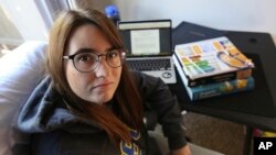 FILE - Ricki Korba, 23, sits for a portrait in her home in Bakersfield, Calif., April 14, 2023.