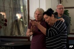 FILE—Osnat Peri, right, whose husband, Haim, is in Hamas captivity, takes part in a Passover Seder with relatives of hostages held in the Gaza Strip, at Kibbutz Nir Oz in Israel, April 11, 2024.