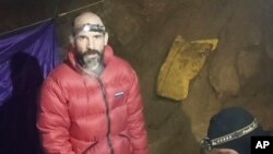 In this screen grab from video, American caver Mark Dickey, 40, talks to camera next to a colleague inside the Morca cave near Anamur, southern Turkey, Sept. 7, 2023.