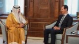 In this photo released by the official Facebook page of the Syrian Presidency, Syrian President Bashar Assad, right, meets with Saudi Arabia ambassador to Jordan Nayef al-Sadiri, in Damascus, May 10, 2023. (Syrian Presidency Facebook page via AP)