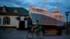 A boy rides a bicycle in what used to be the main port of Aralsk, Kazakhstan, before the Aral Sea dried up, July 4, 2023. 