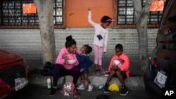 On March 26, 2024, in Mexico City, a migrant family from Venezuela had breakfast beside the railroad tracks lined with temporary tents.