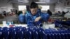 Seorang pekerja merakit alat musik barat di sebuah pabrik di Kabupaten Wuqiang, provinsi Hebei, China utara, 23 Februari 2023. (Mu Yu/Xinhua via AP)