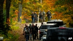 Law enforcement continue a manhunt in the aftermath of a mass shooting, in Durham, Maine, Oct. 27, 2023.