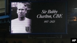 A picture of late English soccer legend Bobby Charlton is displayed on a giant screen during the English Premier League soccer match between Chelsea and Arsenal at Stamford Bridge stadium in London, Oct. 21, 2023.