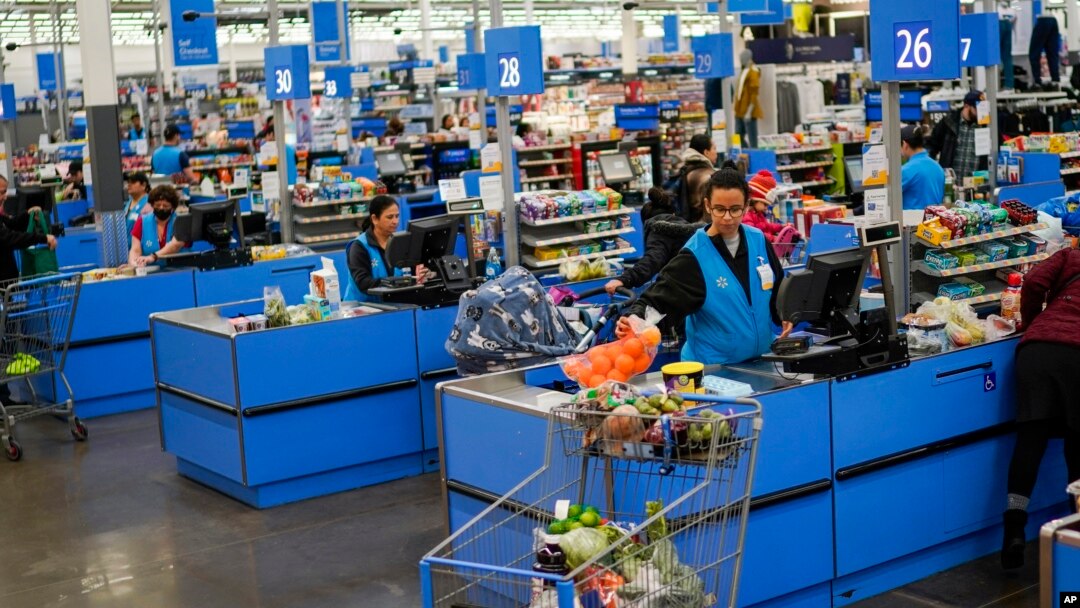 Cashiers process purchases at a Walmart Supercenter in North Bergen, New Jersey, Feb. 9, 2023.