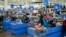 Cashiers process purchases at a Walmart Supercenter in North Bergen, New Jersey, Feb. 9, 2023.