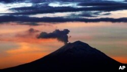 FILE - A plume of ash and steam rises from the Popocatepetl volcano, as seen from Mexico City, Wednesday, June 19, 2019.