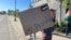 Pro-Palestinian supporters demanding divestment from companies that profit off the Israel-Hamas war hold signs outside as University of Minnesota regents meet, May 10, 2024, in Minneapolis.