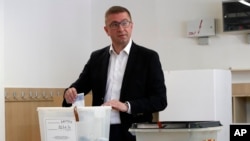 Hristijan Mickoski, the leader of the opposition center-right VMRO-DPMNE party, casts his ballots at a polling station in Skopje, May 8, 2024.