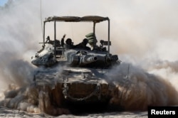 An Israeli tank maneuvres near the Israel-Gaza border, amid the Israel-Hamas conflict, July 2, 2024.
